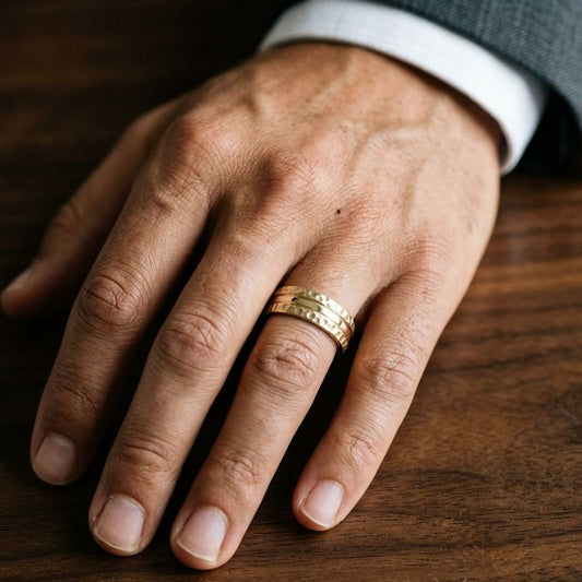 7.5mm Hammered Finish Carved Wedding Band in 18K Yellow Gold, worn on hand, masculine close-up