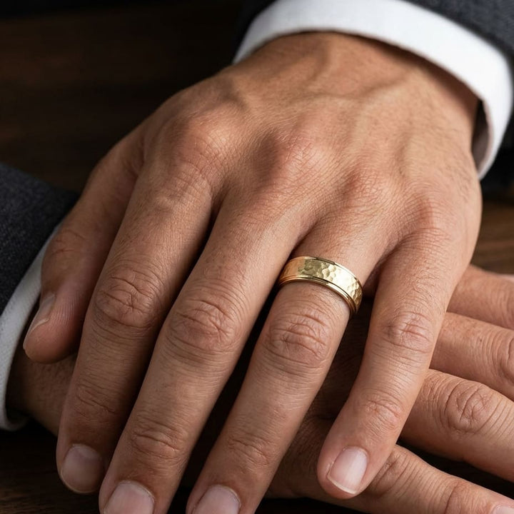 8mm Hammered Finish Carved Wedding Band in 18K Yellow Gold, worn on hand, masculine close-up