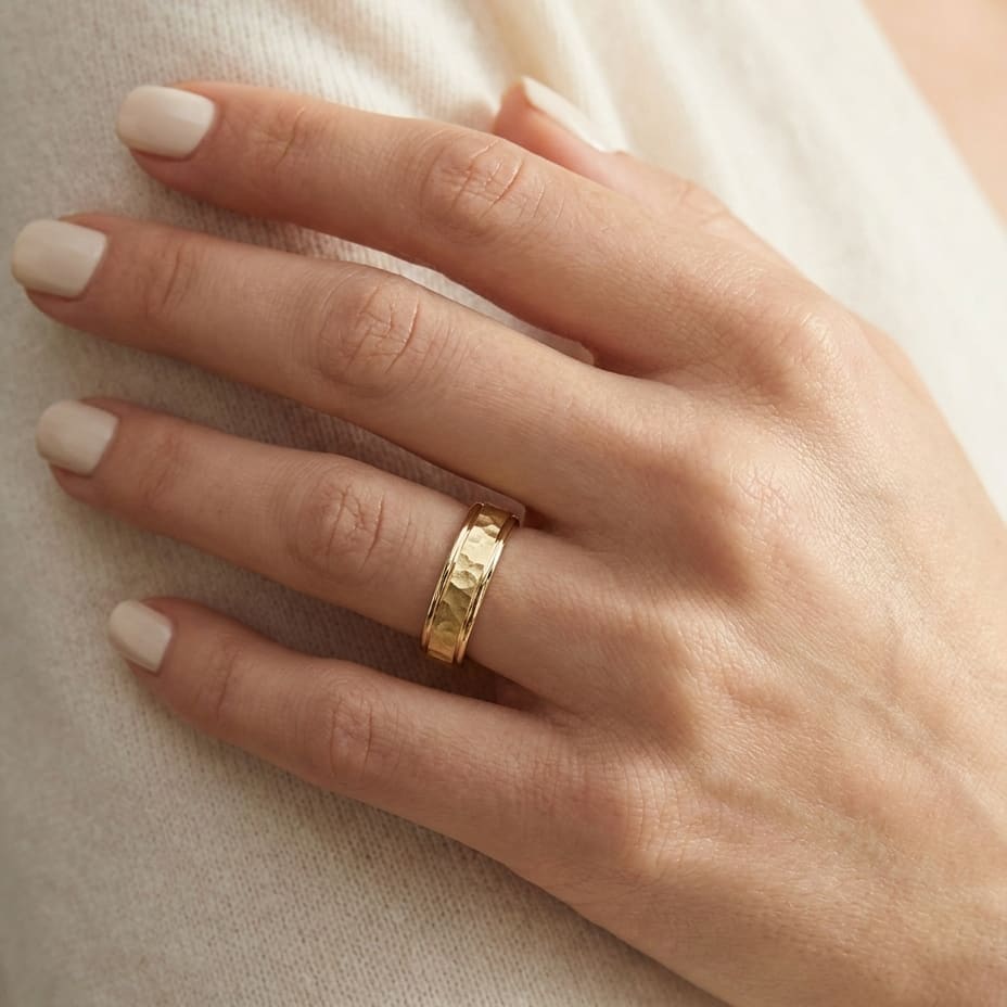 4mm Hammered Finish Carved Wedding Band in 18K Yellow Gold, worn on hand, close-up