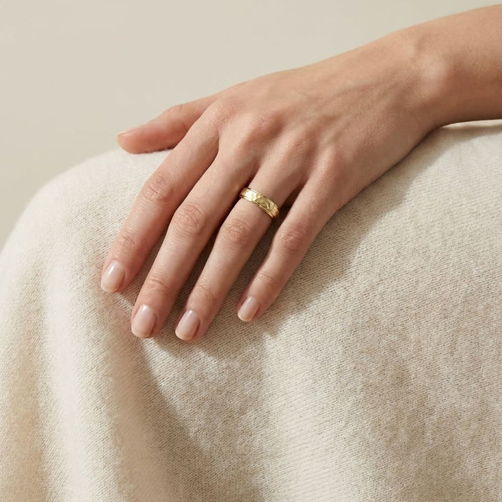 4mm Hammered Finish Carved Wedding Band in 18K Yellow Gold, worn on hand, full view