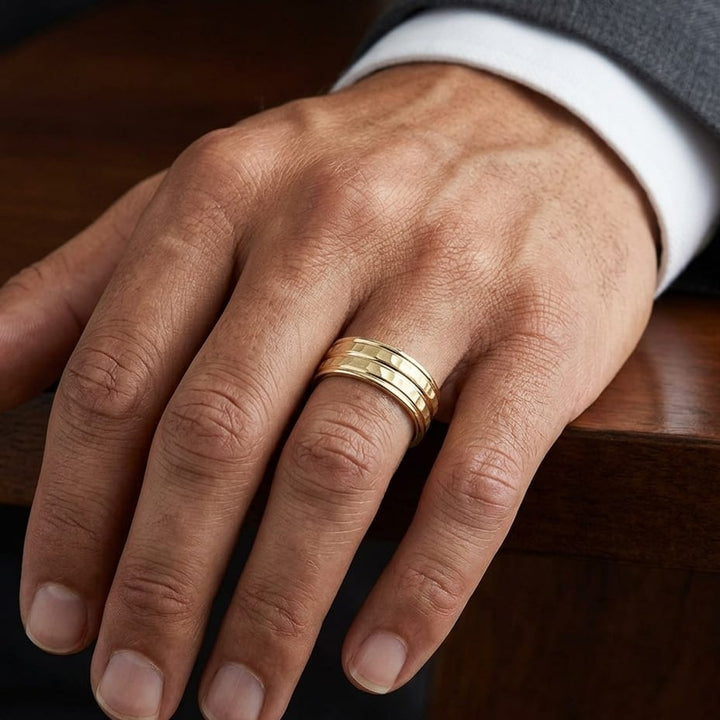 7.5mm High Polish Round Edge Carved Wedding Band in 18K Yellow Gold, worn on hand, masculine close-up