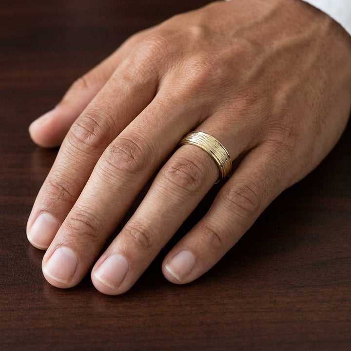 7.5mm Comfort-Fit Wedding Band in 18K Yellow Gold, worn on hand, masculine close-up