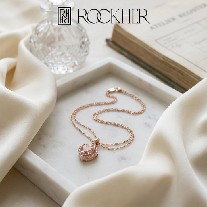 Morganite and Diamond Halo Heart Pendant in 14k Rose Gold 0.24ctw, on marble vanity tray with silk