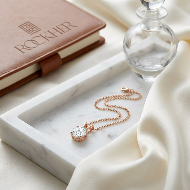 Natural Diamond Round Brilliant Solitaire Pendant in 14K Rose Gold, 2 ct. t.w., on marble vanity tray with silk