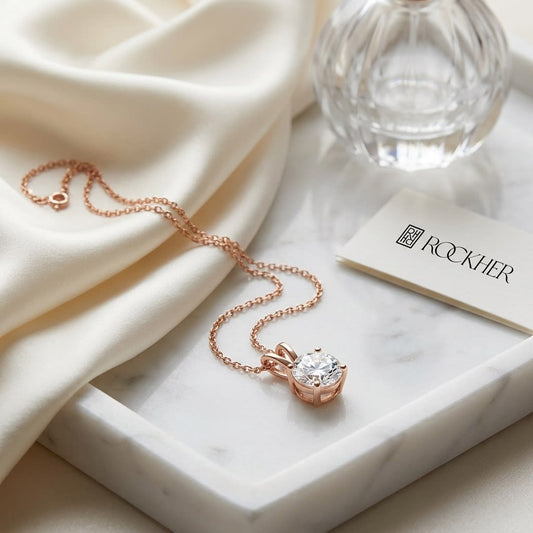 Natural Diamond Round Brilliant Solitaire Pendant in 14K Rose Gold, 2 ct. t.w., on marble vanity tray with silk