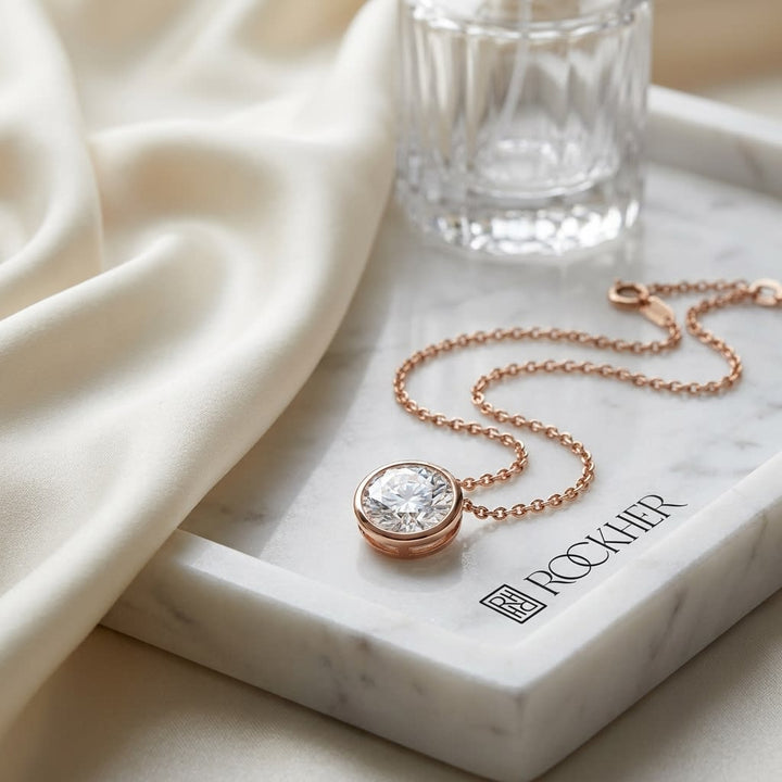 Natural Diamond Round Brilliant Solitaire Pendant in 14K Rose Gold, 4 ct. t.w., on marble vanity tray with silk