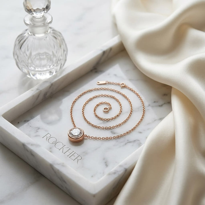 Natural Diamond Round Brilliant Solitaire Pendant in 14K Rose Gold, 1 ct. t.w., on marble vanity tray with silk