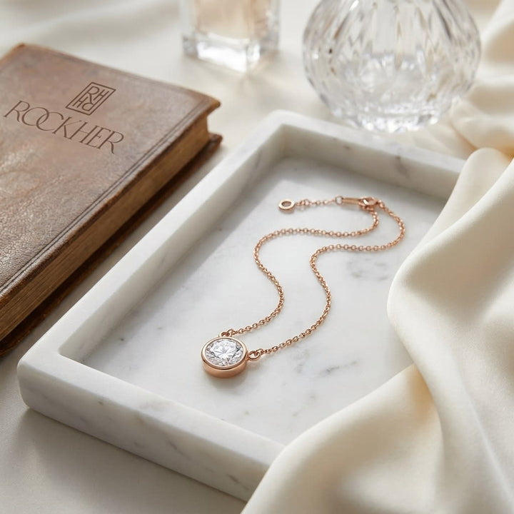 Natural Diamond Round Brilliant Solitaire Pendant in 14K Rose Gold, 2 ct. t.w., on marble vanity tray with silk