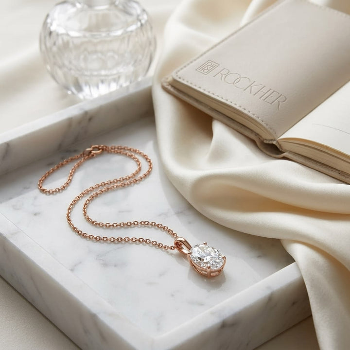 Natural Diamond Oval Solitaire Pendant in 14K Rose Gold, 4 ct. t.w., on marble vanity tray with silk