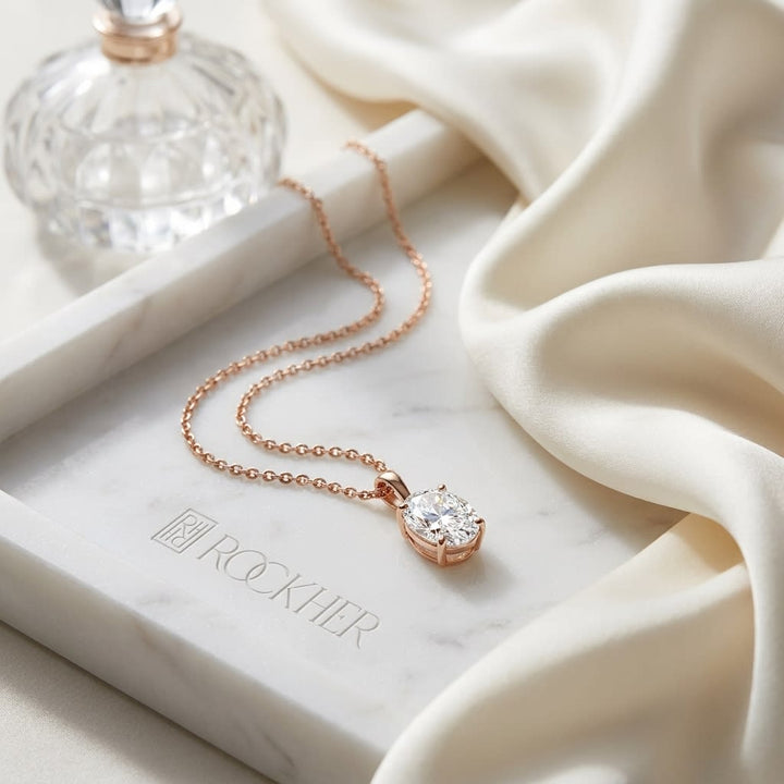 Natural Diamond Oval Solitaire Pendant in 14K Rose Gold, 4 ct. t.w., on marble vanity tray with silk
