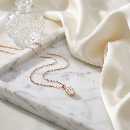 Natural Diamond Oval Solitaire Pendant in 14K Rose Gold, 2 ct. t.w., on marble vanity tray with silk