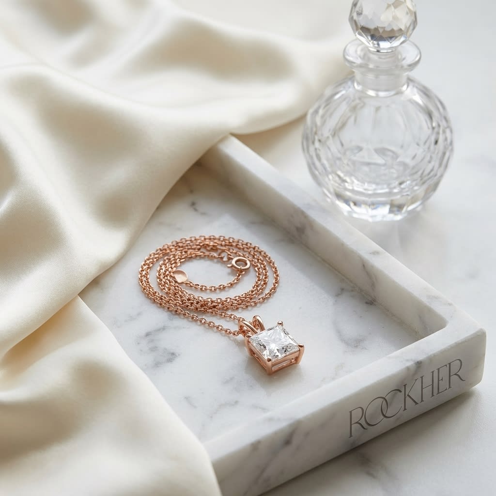 Natural Diamond Princess Cut Solitaire Pendant in 14K Rose Gold, 2 ct. t.w., on marble vanity tray with silk