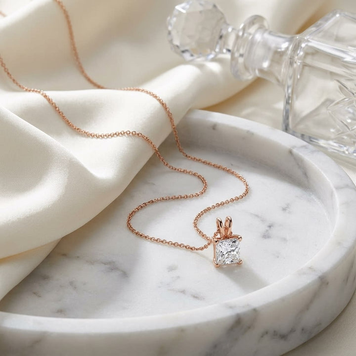 Natural Diamond Princess Cut Solitaire Pendant in 14K Rose Gold, 3 ct. t.w., on marble vanity tray with silk