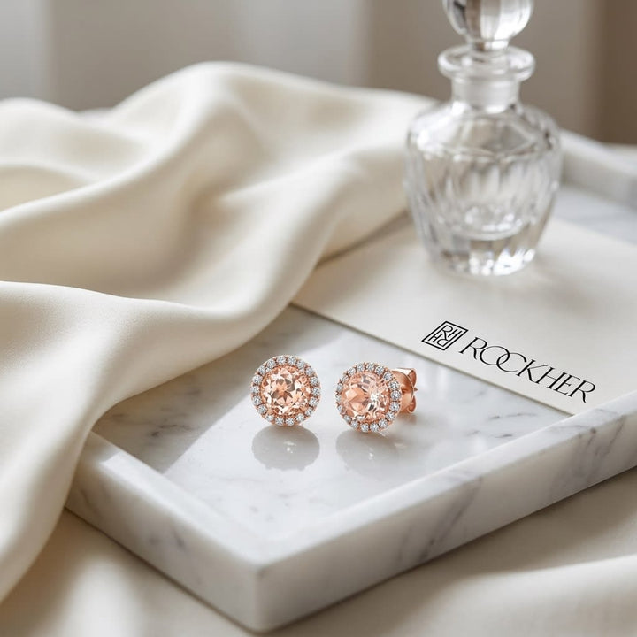 Morganite Round Brilliant Stud Earrings in 14K Rose Gold, on marble vanity tray with silk