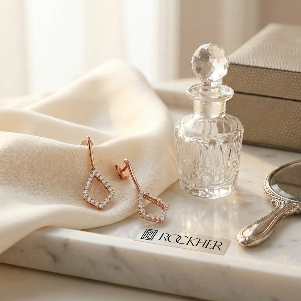 Diamond Drop Earrings in 14K Rose Gold, on marble vanity tray with silk