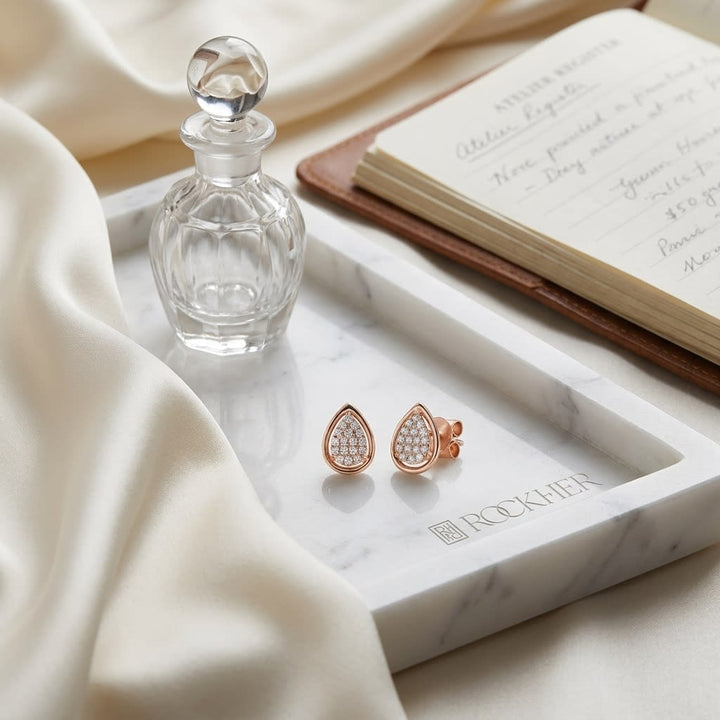 Natural Diamond Round Brilliant Stud Earrings in 14K Rose Gold, on marble vanity tray with silk