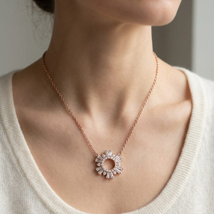 Diamond Pave Circle And Tapered Baguette Starburst Necklace in 14K Rose Gold, worn close-up portrait