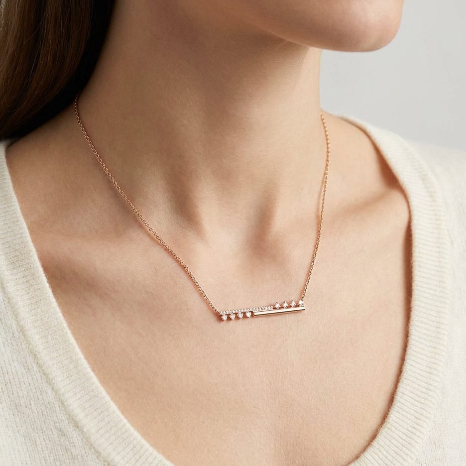 Diamond Half-bar And Pave Necklace With Prong-set Accents in 14K Rose Gold, worn close-up portrait