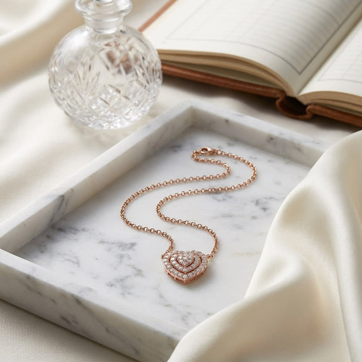 Diamond Heart Cluster Necklace With Pave Double Border in 14K Rose Gold, on marble vanity tray with silk