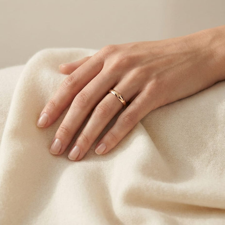 2.5mm Slightly Domed Traditional Oval Wedding Band in 14K Rose Gold, worn on hand, full view