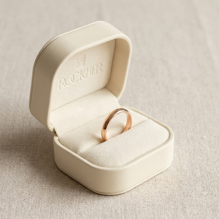 2.5mm Slightly Domed Traditional Oval Wedding Band in 14K Rose Gold, in navy velvet jewelry box