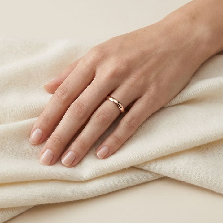 3mm Slightly Domed Traditional Oval Wedding Band in 14K Rose Gold, worn on hand, full view