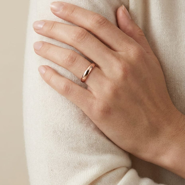 4mm Slightly Domed Traditional Oval Wedding Band in 14K Rose Gold, worn on hand, full view