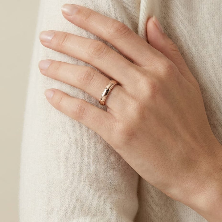 4mm Slightly Domed Traditional Oval Milgrain Wedding Band in 14K Rose Gold, worn on hand, full view