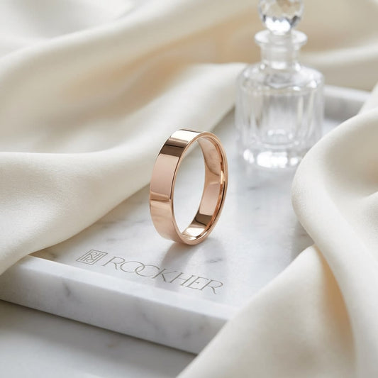4mm Flat Comfort-Fit Wedding Band in 14K Rose Gold, on marble vanity tray with silk