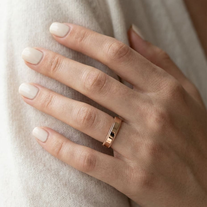 4mm Flat Milgrain Comfort-Fit Wedding Band in 14K Rose Gold, worn on hand, close-up