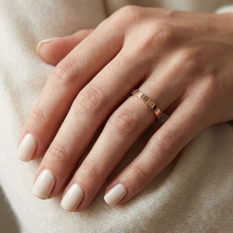 2mm High Polish Carved Wedding Band in 14K Rose Gold, worn on hand, close-up