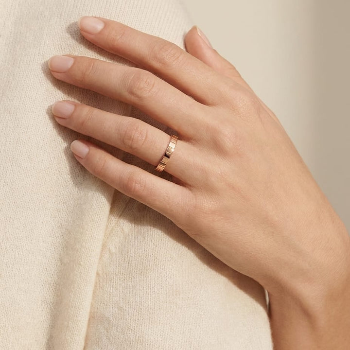 2mm High Polish Carved Wedding Band in 14K Rose Gold, worn on hand, full view