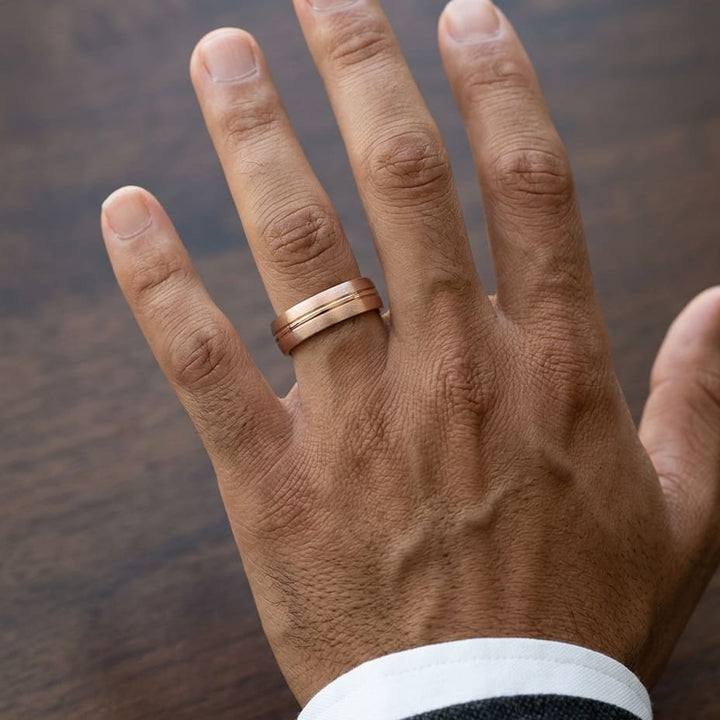 6mm Satin Finish High Polished Center Cut Carved Wedding Band in 14K Rose Gold, worn on hand, masculine close-up