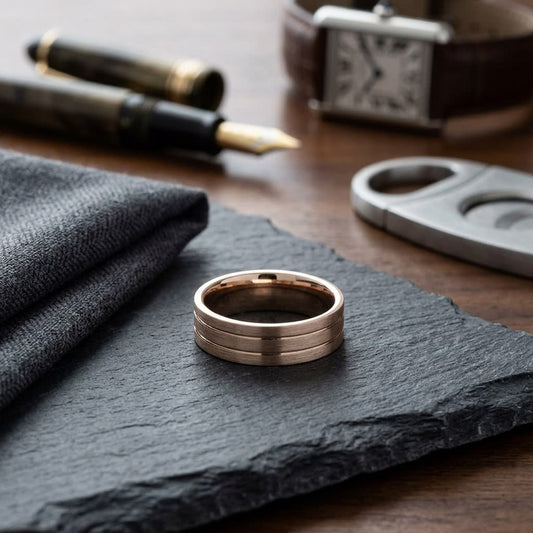 6mm Satin Finish Parallel Center Cut Carved Wedding Band in 14K Rose Gold, on walnut surface with pocket square