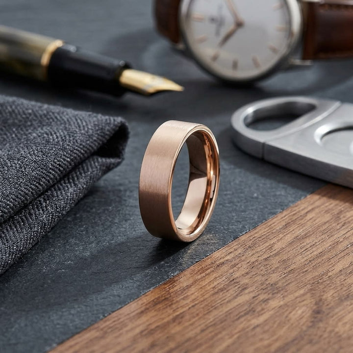 6mm Satin Finish Carved Wedding Band in 14K Rose Gold, on walnut surface with pocket square