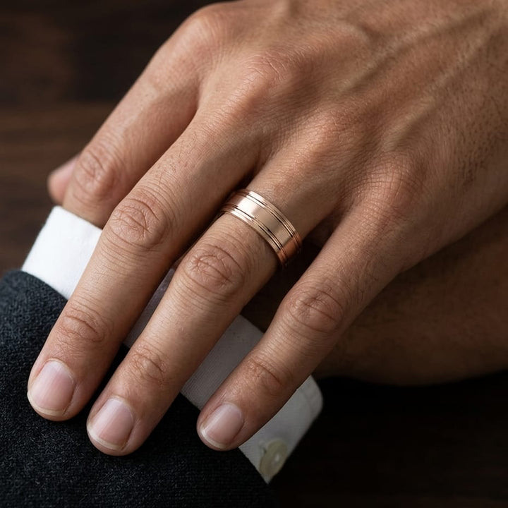7mm Satin Finish Parallel Groove Carved Wedding Band in 14K Rose Gold, worn on hand, masculine close-up