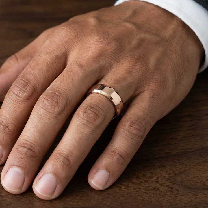 6mm High Polish Carved Wedding Band in 14K Rose Gold, worn on hand, masculine close-up