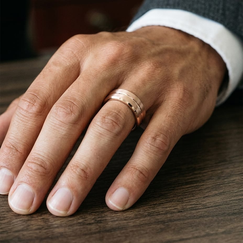 6mm Satin Finish Carved Wedding Band in 14K Rose Gold, worn on hand, masculine close-up