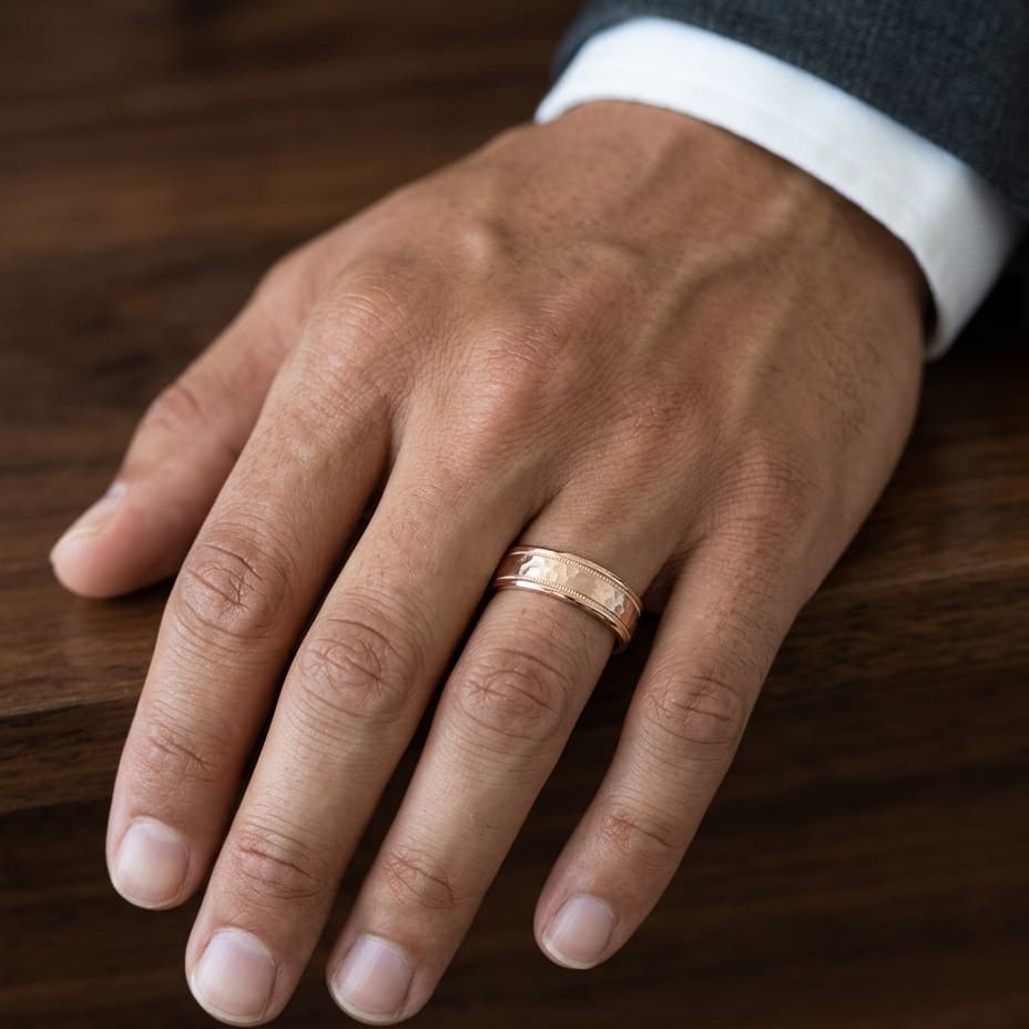 6mm Hammered Center High Polish Round Edge Carved Wedding Band in 14K Rose Gold, worn on hand, masculine close-up