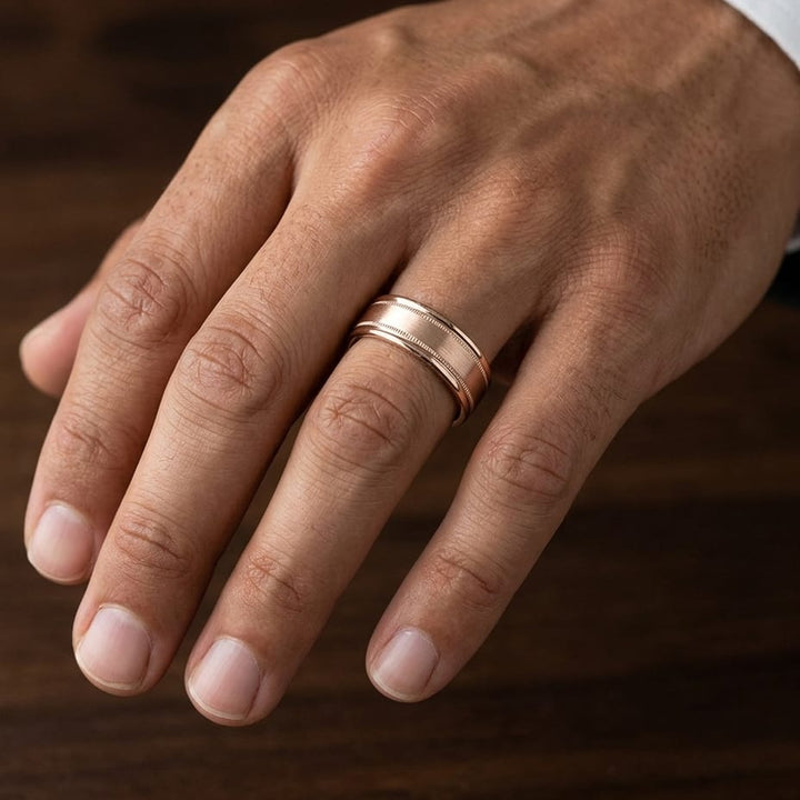 8mm Satin Finish Milgrain Round Edge Carved Wedding Band in 14K Rose Gold, worn on hand, masculine close-up