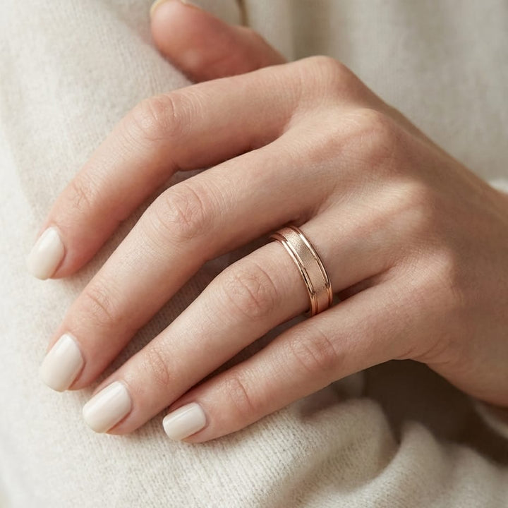 4mm Wired Finish High Polished Round Edge Carved Wedding Band in 14K Rose Gold, worn on hand, close-up