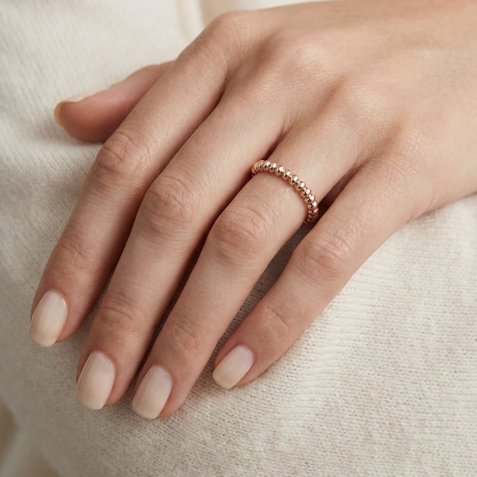 2mm Comfort-Fit Wedding Band in 14K Rose Gold, worn on hand, close-up