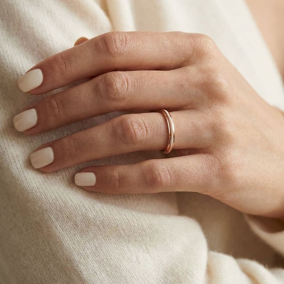 2mm High Polish Milgrain Round Edge Carved Wedding Band in 14K Rose Gold, worn on hand, close-up