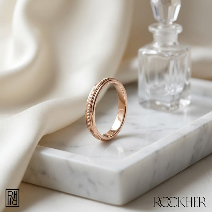 2mm High Polish Milgrain Round Edge Carved Wedding Band in 14K Rose Gold, on marble vanity tray with silk