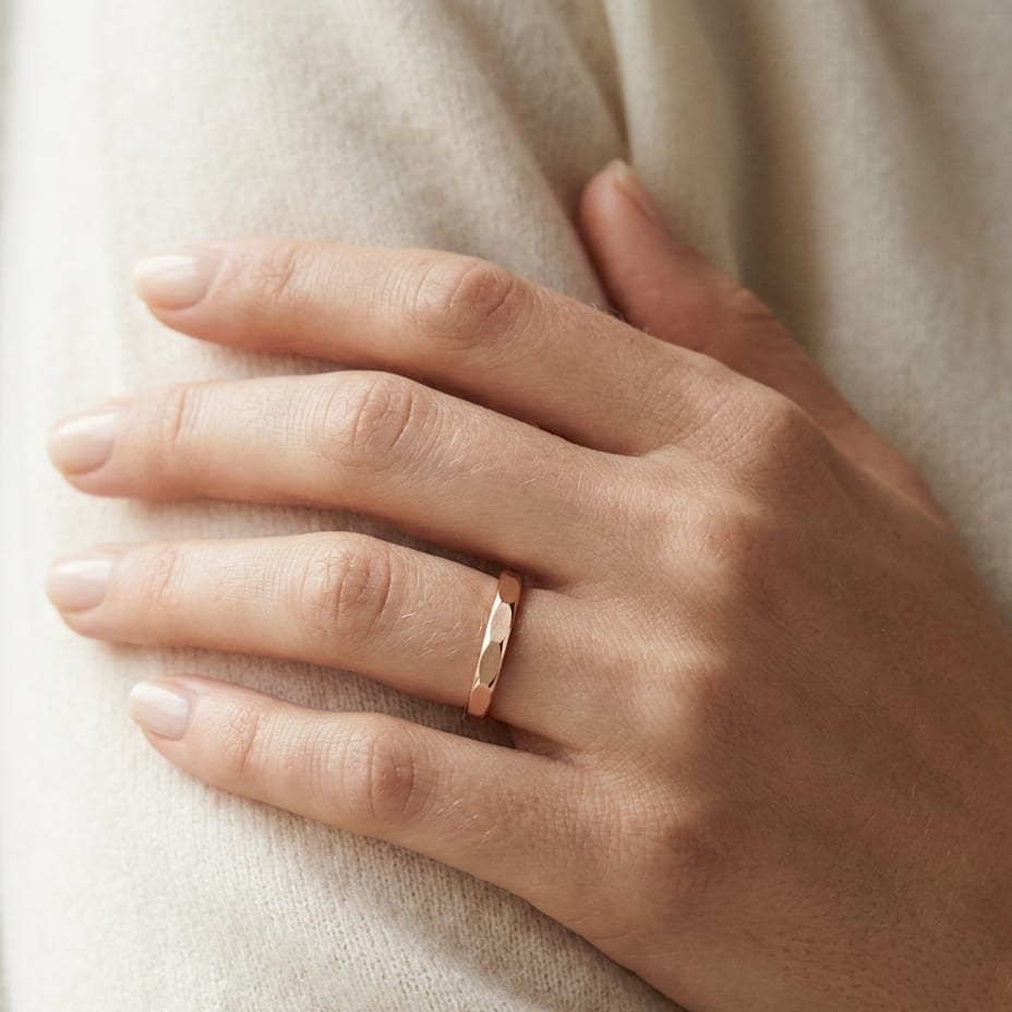 2mm High Polish Carved Wedding Band in 14K Rose Gold, worn on hand, close-up