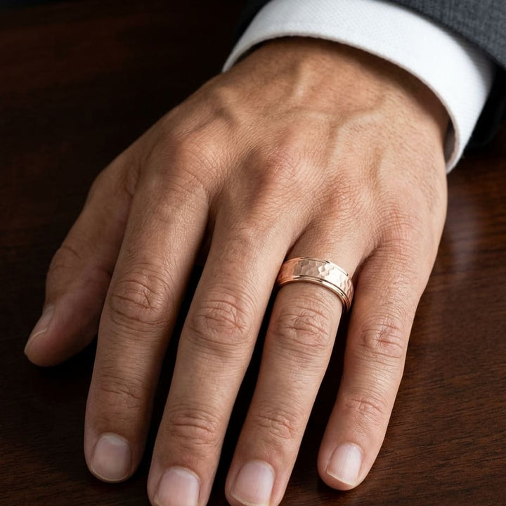 8mm Hammered Finish Carved Wedding Band in 14K Rose Gold, worn on hand, masculine close-up