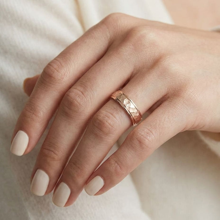 4mm Hammered Finish Carved Wedding Band in 14K Rose Gold, worn on hand, close-up