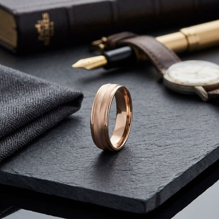 6mm High Polish Round Edge Carved Wedding Band in 14K Rose Gold, on walnut surface with pocket square