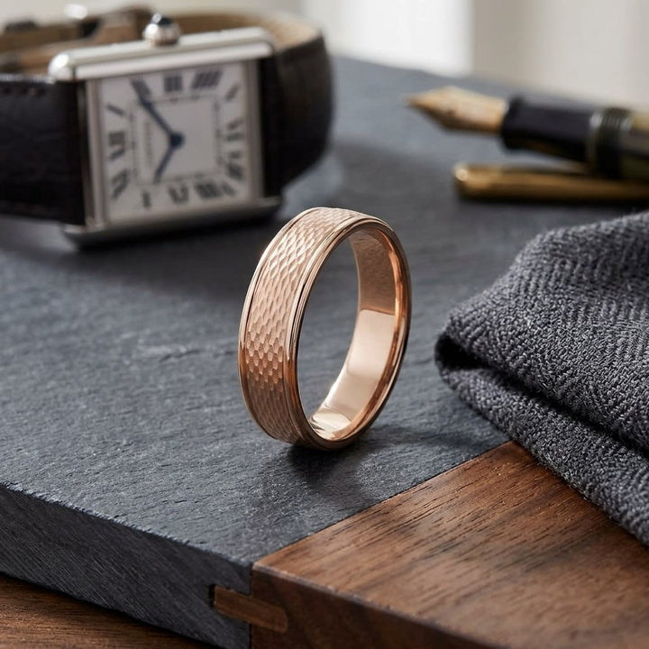 4.5mm Round Edge Mesh Center Carved Wedding Band in 14K Rose Gold, on walnut surface with pocket square