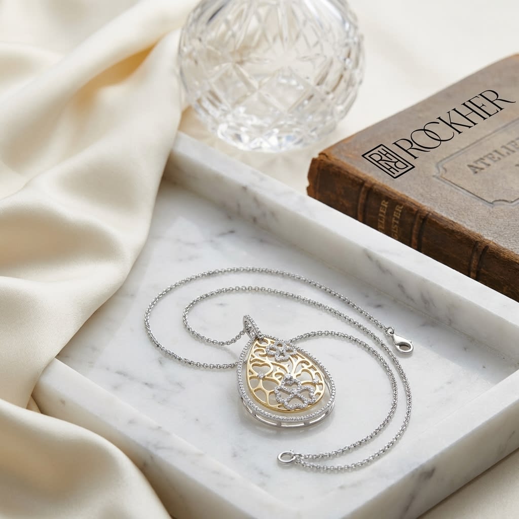 Diamond Tear Drop Scrolled Lattice Pendant In 14k Yellow And White Gold, on marble vanity tray with silk